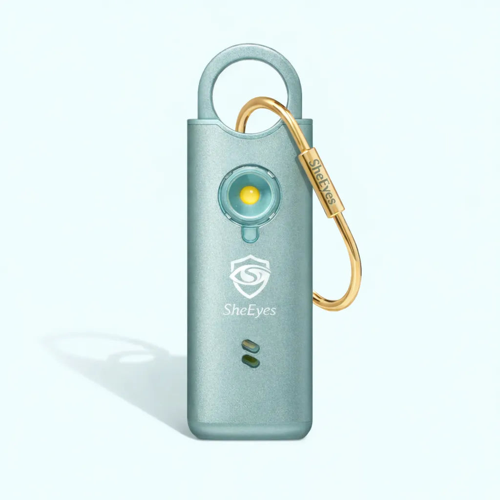 SheEyes Pro mint green personal safety alarm with gold carabiner